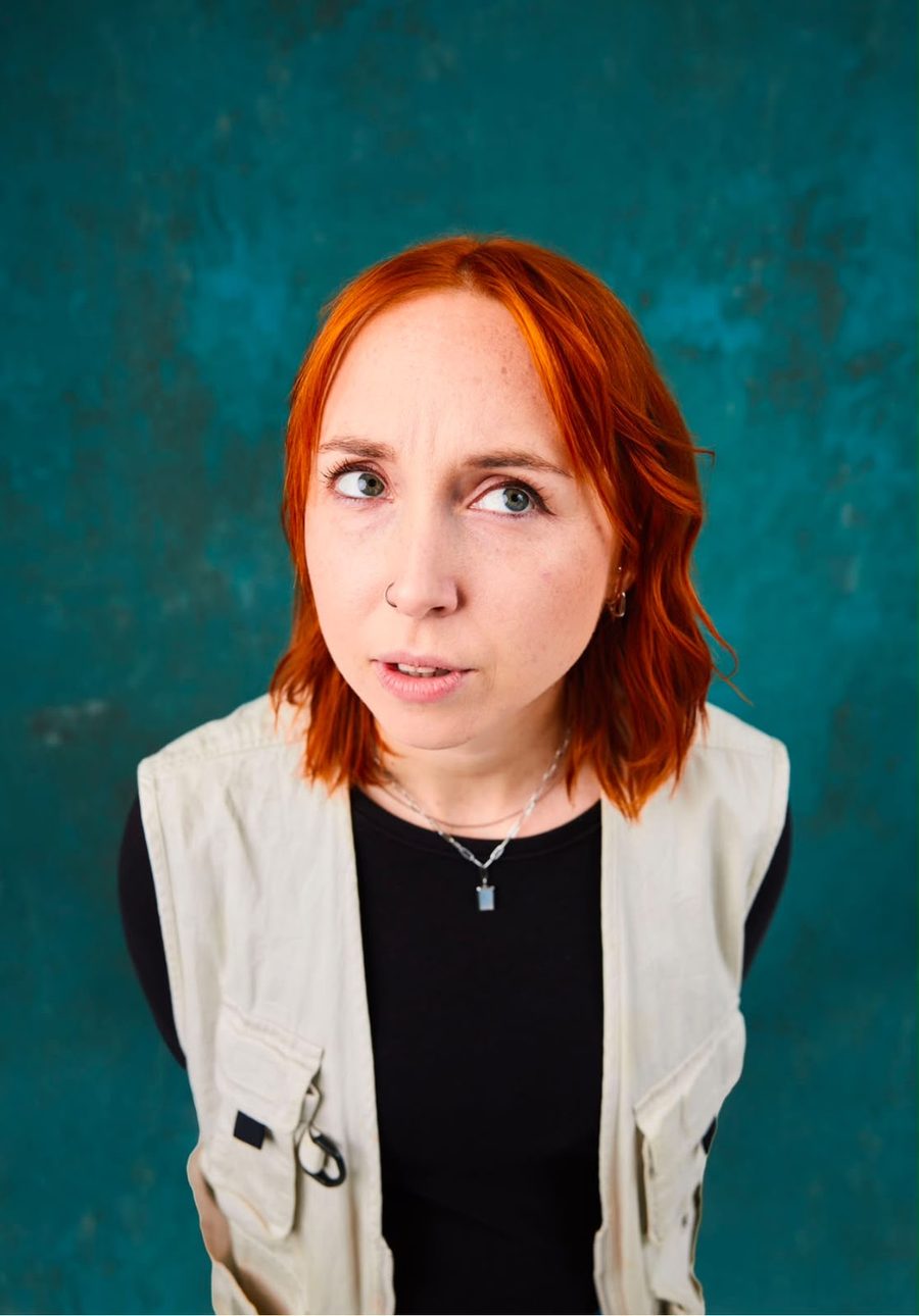 Shannon Brooke, red-haired comedian, looking off to the side